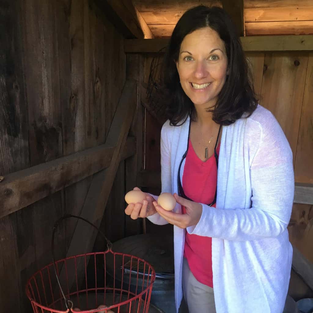 Author of the blog holding eggs and looking at the camera.