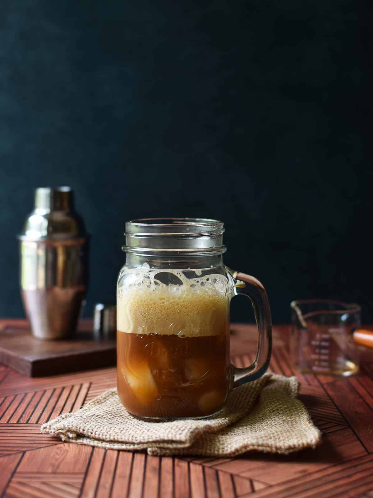 Brown sugar shaken chai tea in a glass mug with a handle.