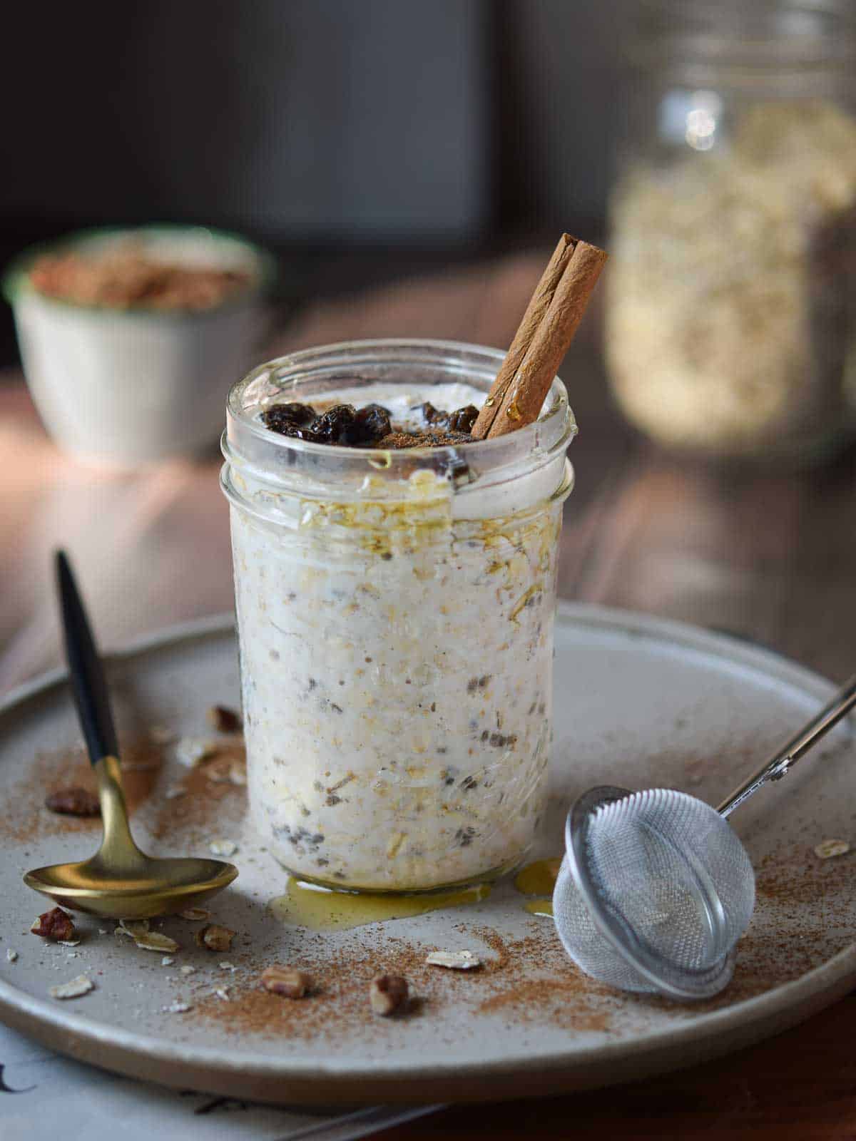 Overnight oats in a jar with cinnamon and raisins.