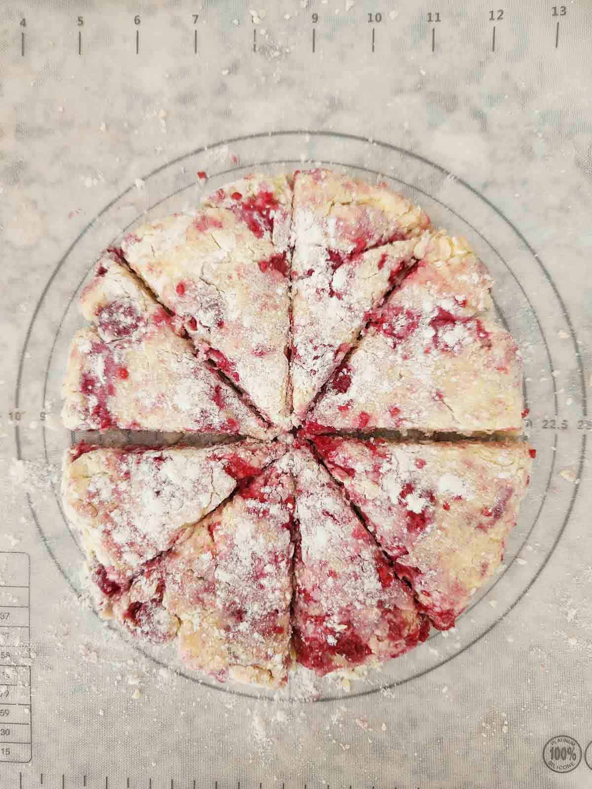 Raspberry scone dough in a circle and cut into 8 even triangles.