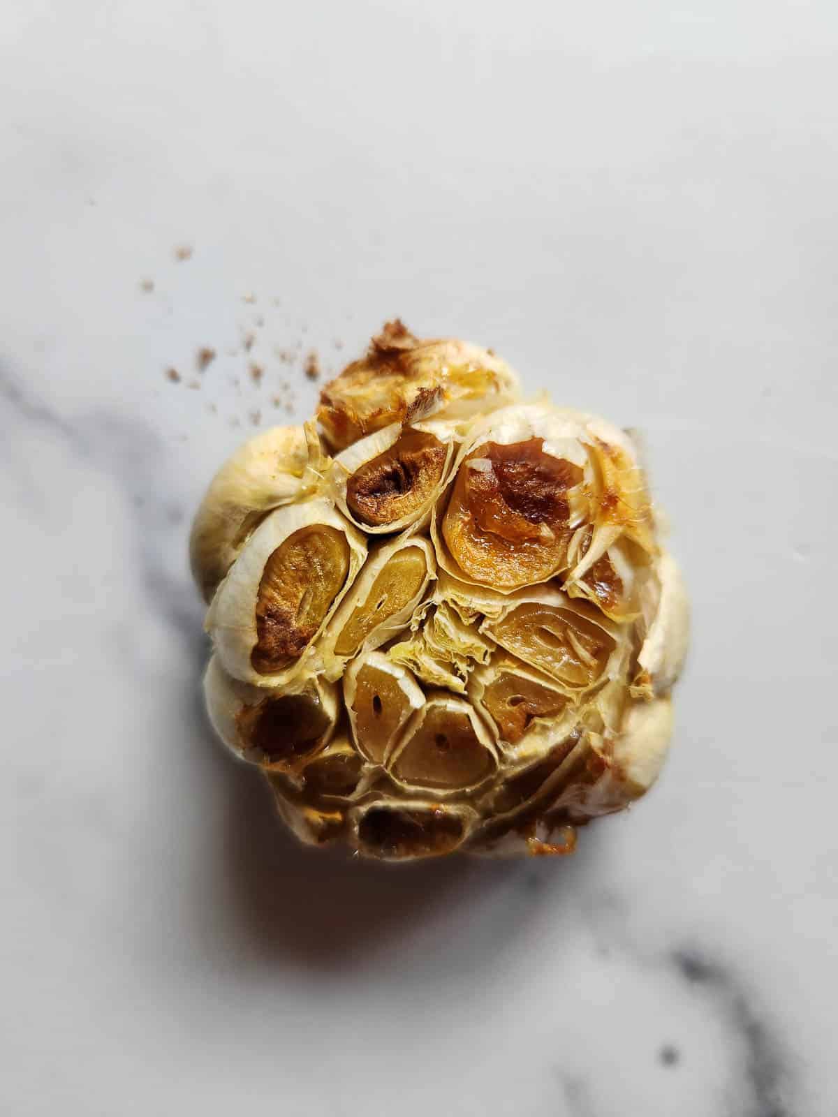 Oven-roasted garlic on a white background.