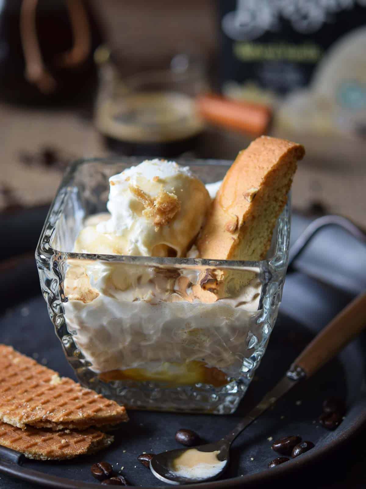 Close-up of an Italian affogato in a clear class with a cookie in it.