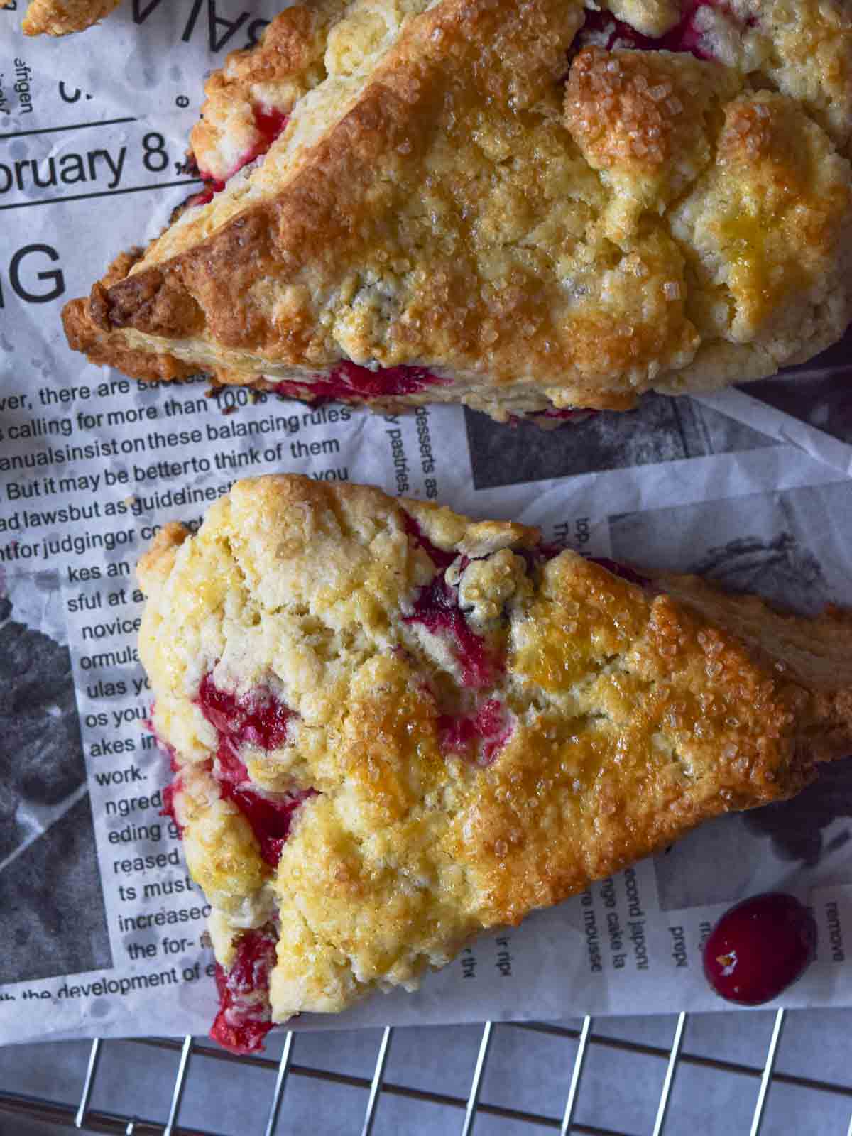 Overhead view of cranberry orange scones on a wire rack.