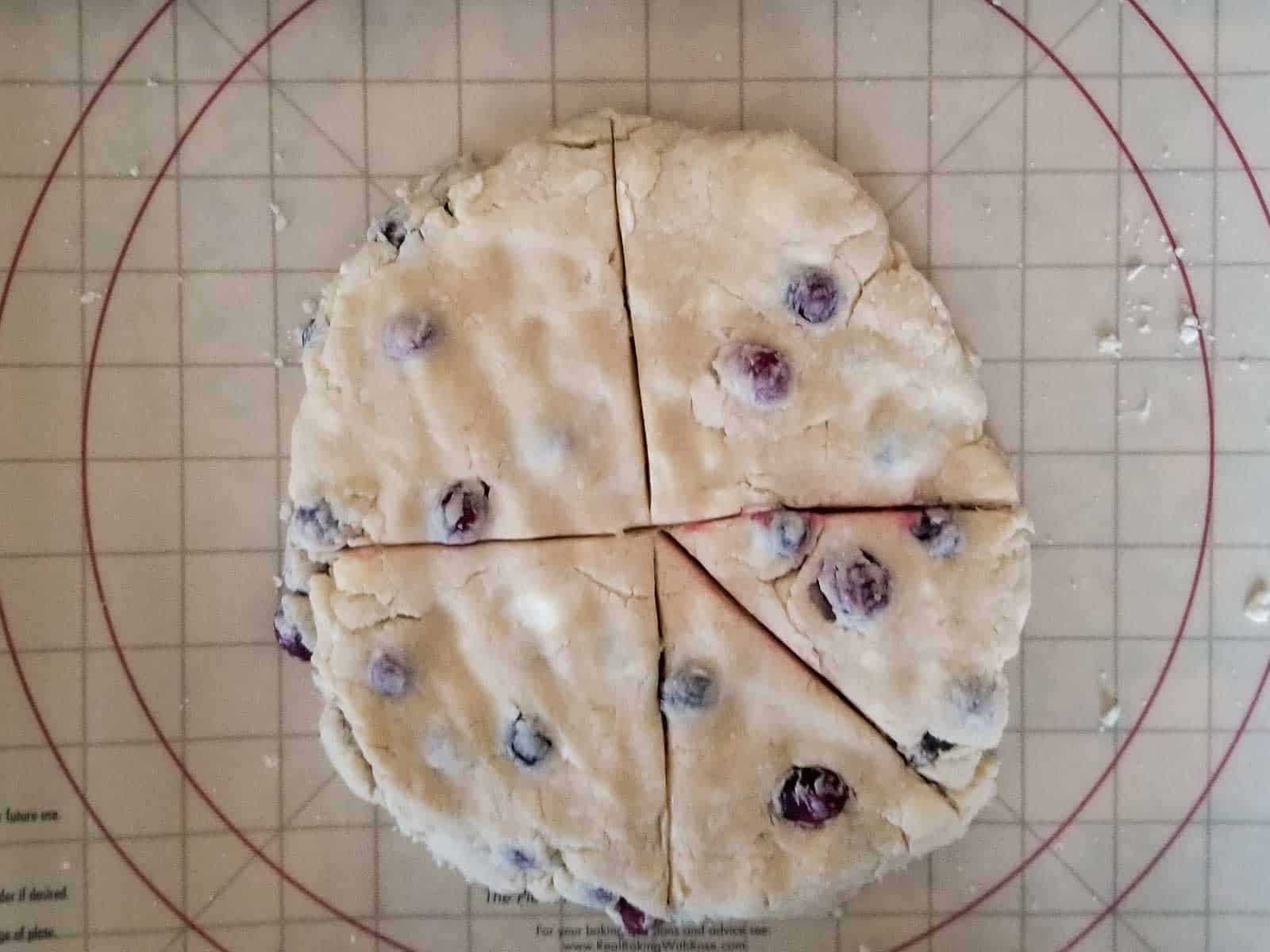 Cutting scone dough into triangles.