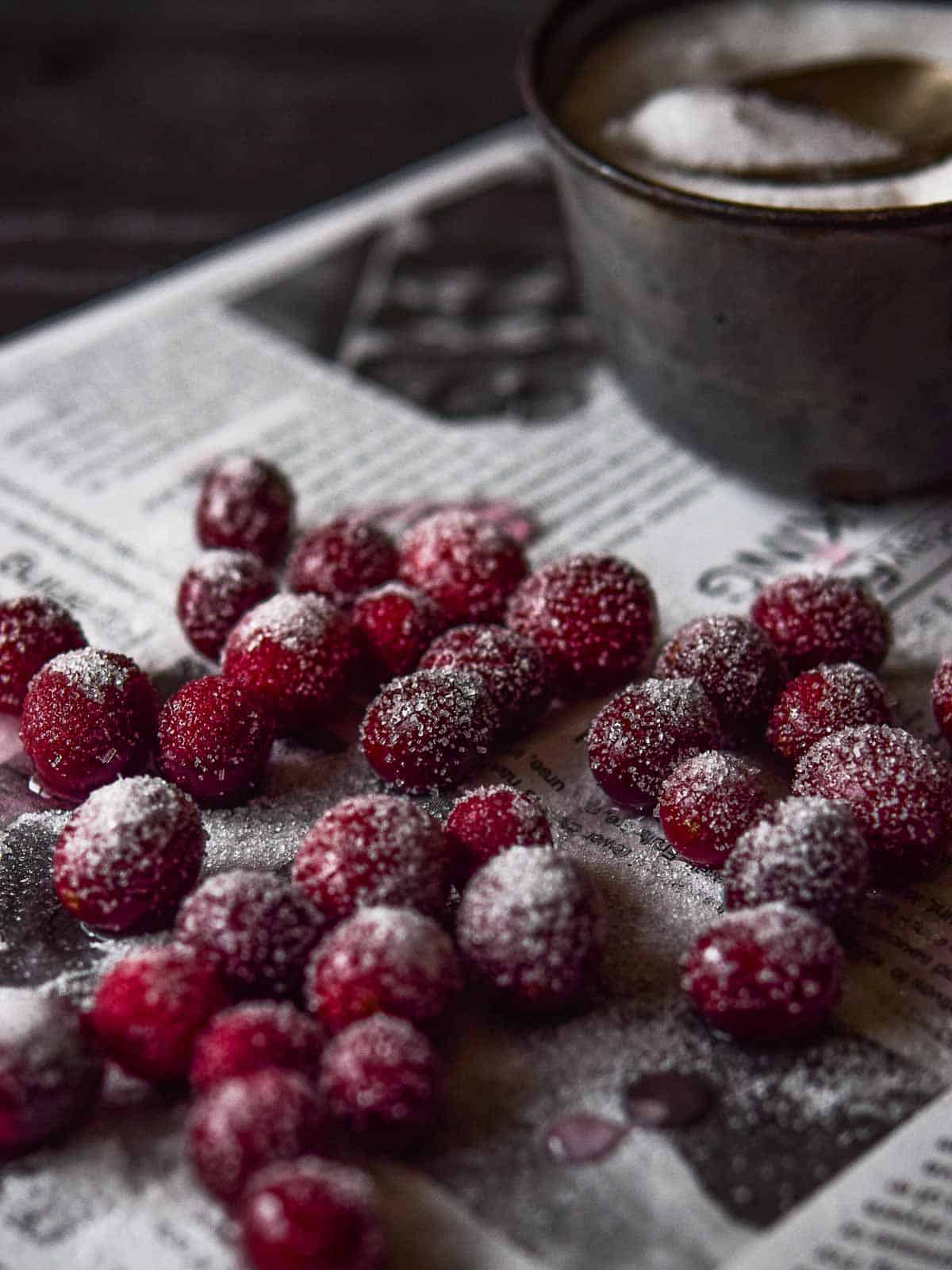 Sugared cranberries on parchment paper.