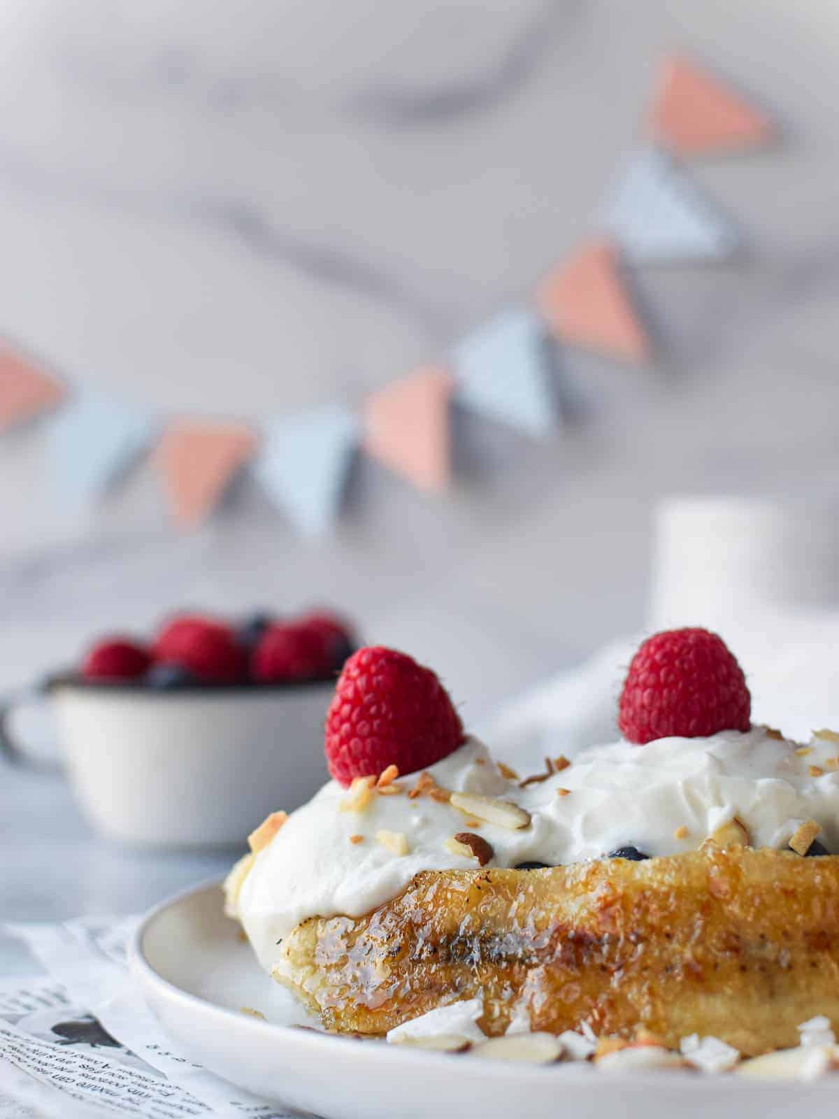 Breakfast banana split with yogurt with fresh fruit and nuts.