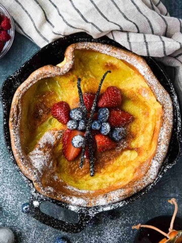 Overhead picture of a vanilla Dutch baby with fruit in the middle.