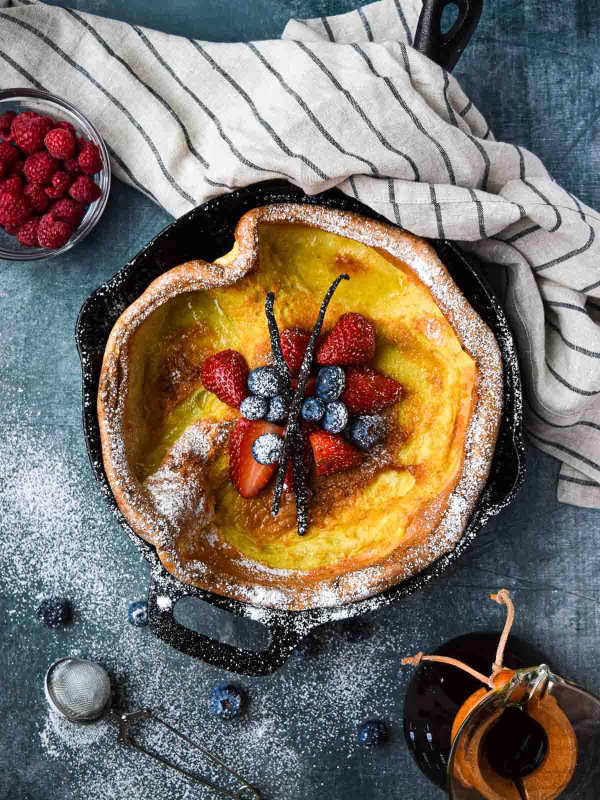 Overhead picture of a vanilla Dutch baby with fruit in the middle.