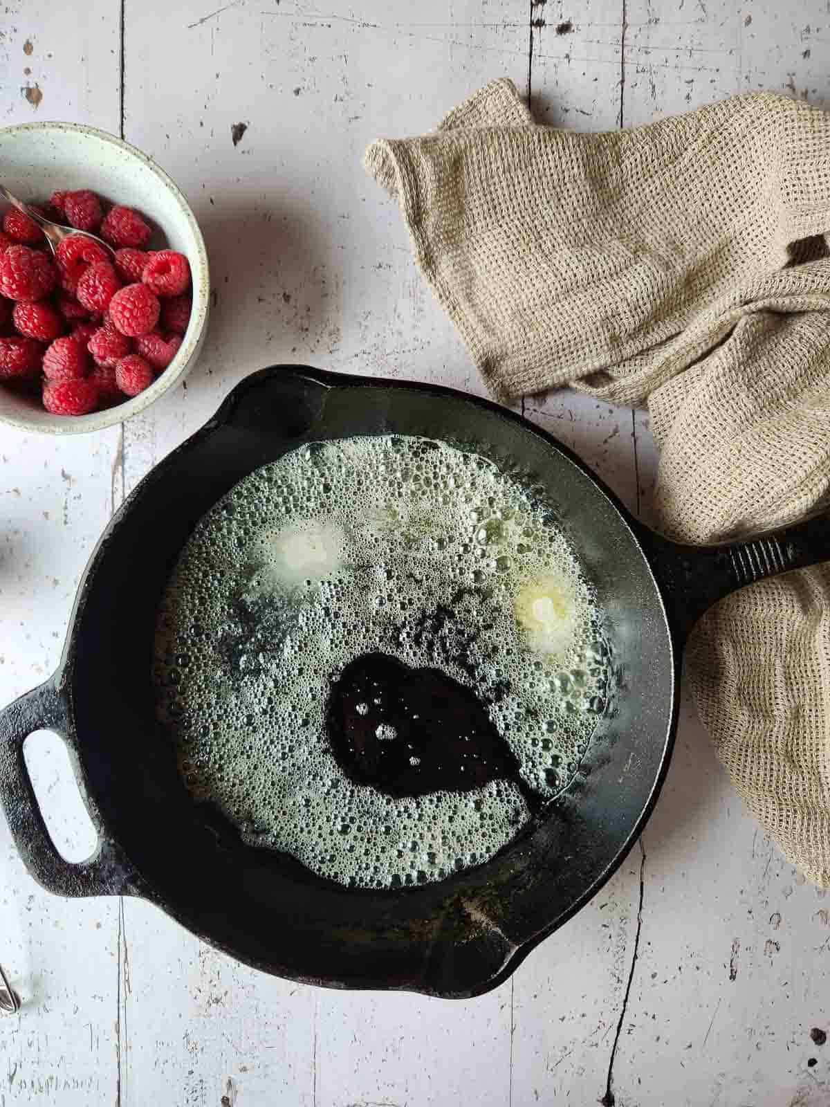 Melted butter prepared in a hot cast iron skillet.