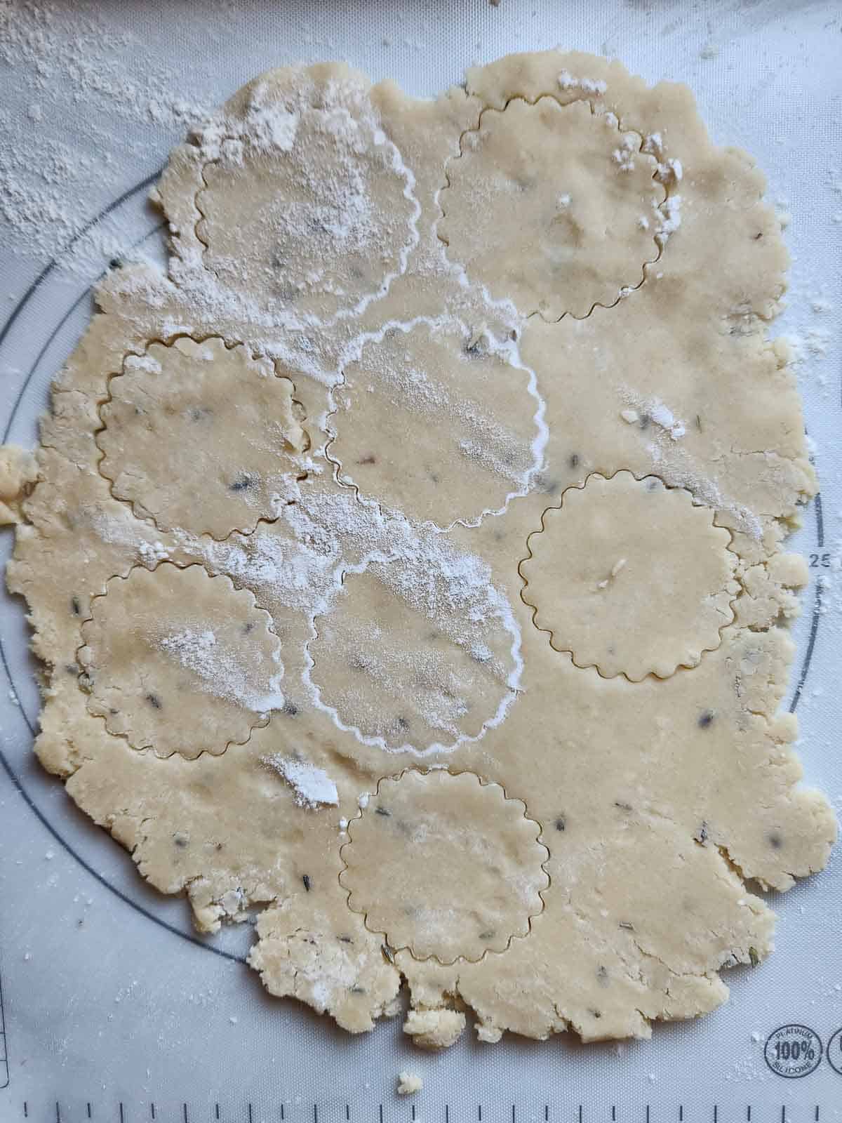 Lemon lavender shortbread dough cut out with a cookie cutter.