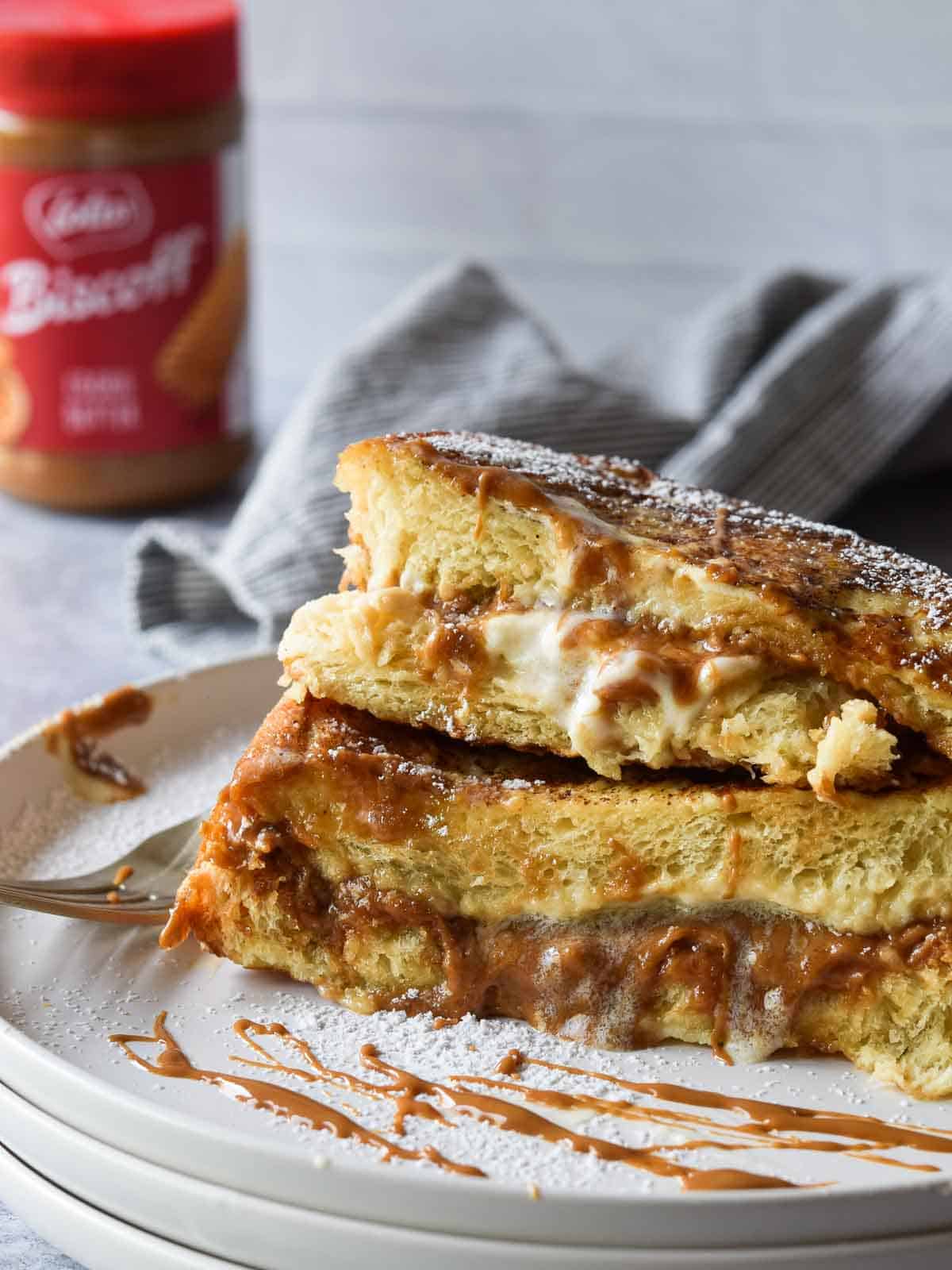 Biscoff stuffed French toast cut open on a white plate.