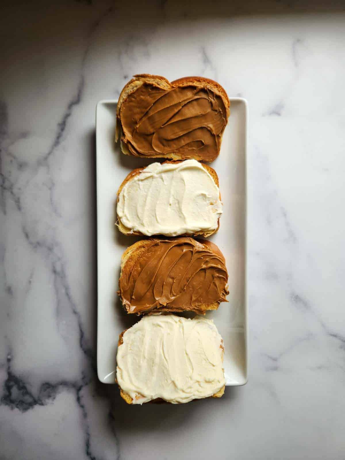 Biscoff and cream cheese spread on 4 pieces of bread.