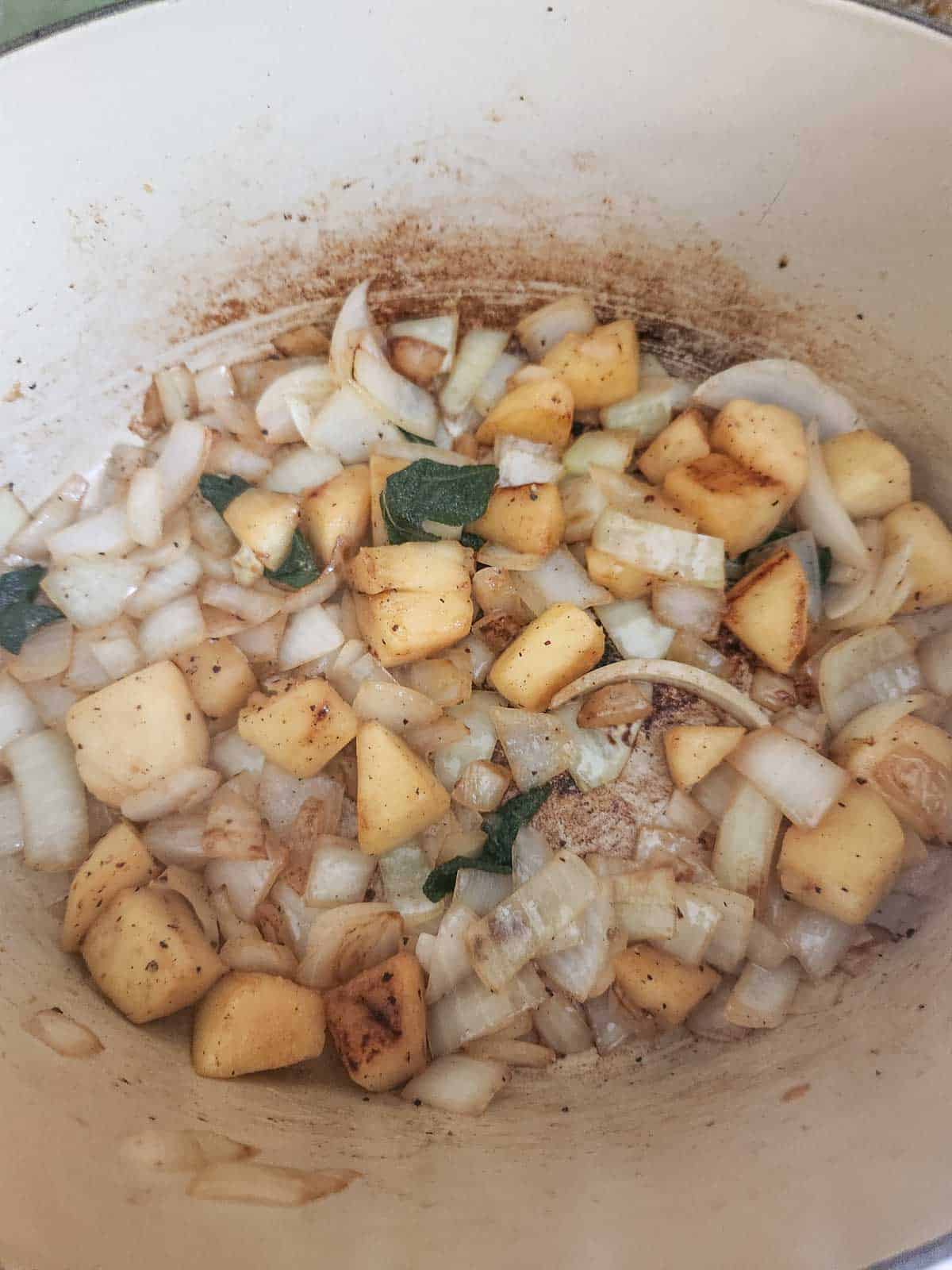 Sautéed vegetables in a pot for soup.
