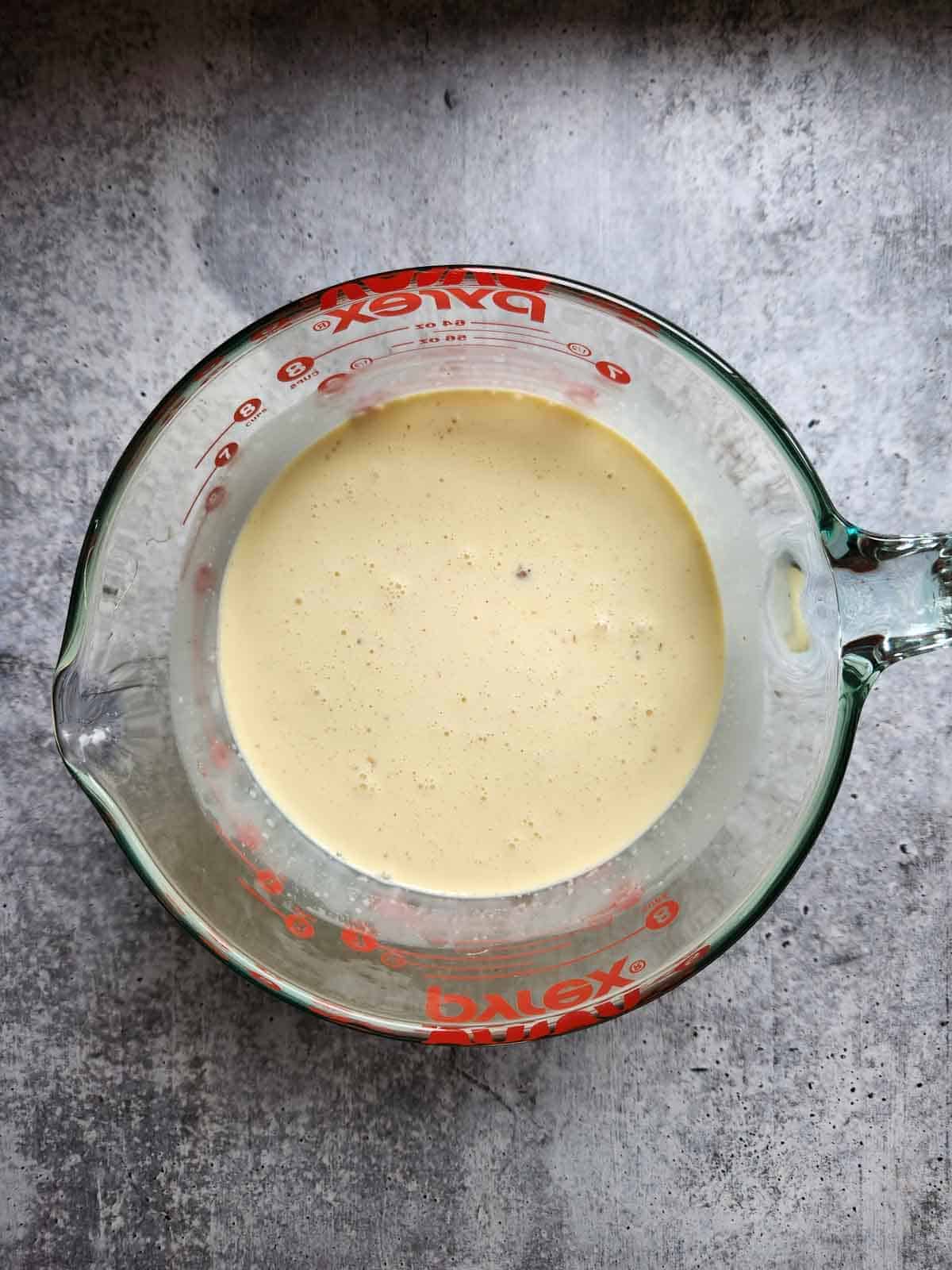 Mixed ice cream batter in a clear bowl.