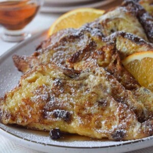 Close-up of French toast with orange and maple syrup.