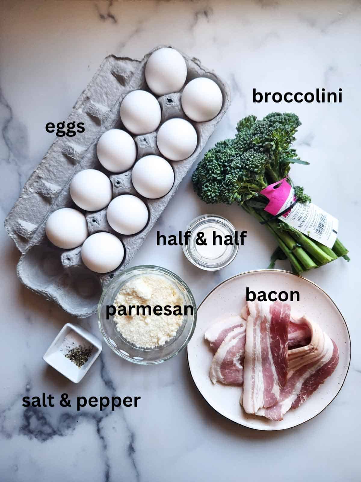 Overhead view of broccolini frittata ingredients on white marble.
