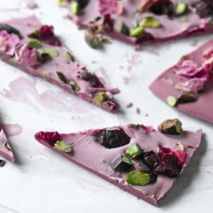 Cut up pieces of ruby chocolate bark on parchment paper.