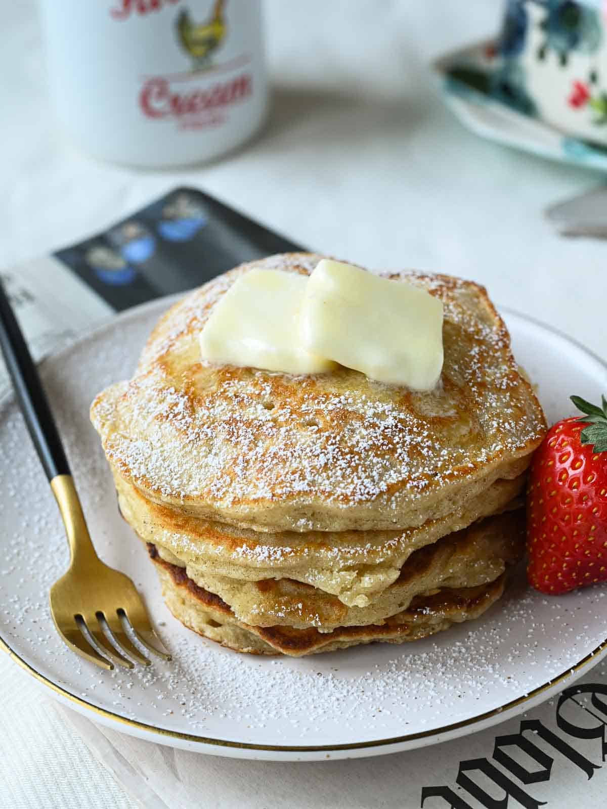 Close-up of a pancake stack with butter on top.