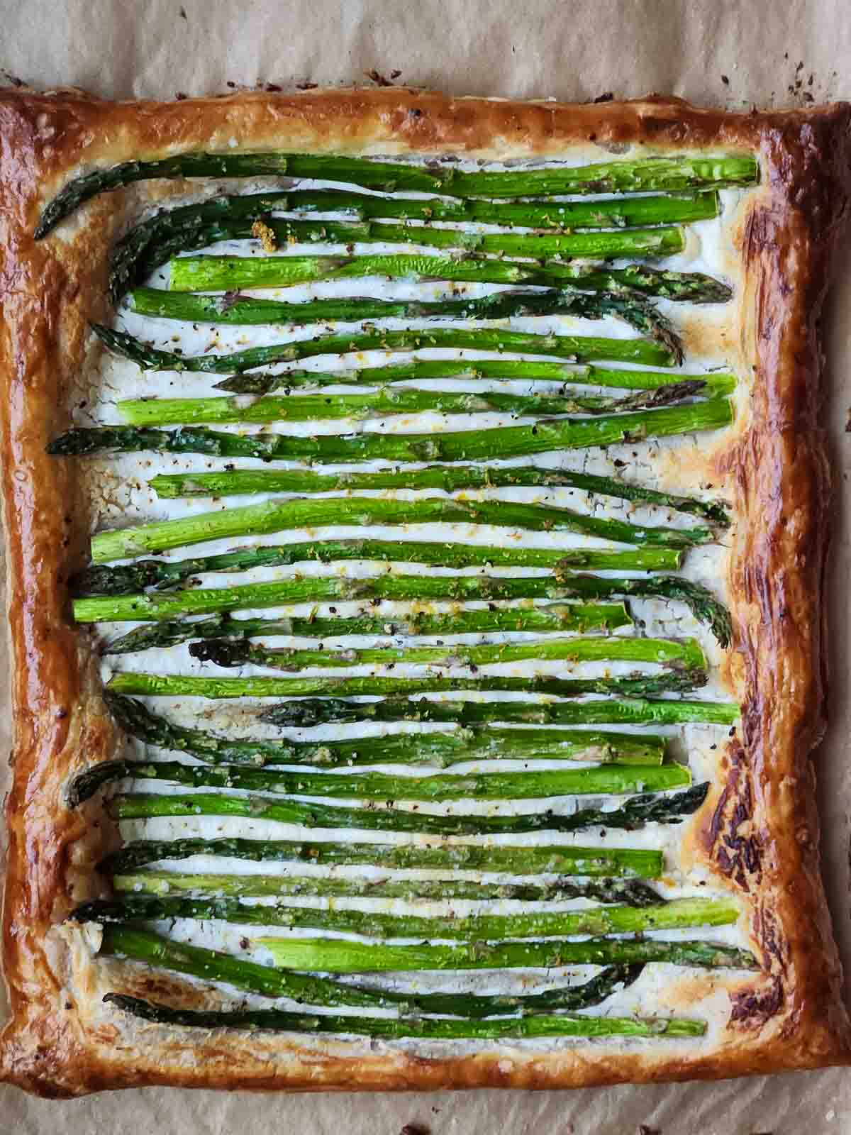 Overhead view of asparagus puff pastry with goat cheese.