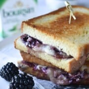 Cloe-up of blackberry grilled cheese with blackberries in the foreground.