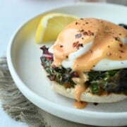 Close-up of eggs Florentine with tomato hollandaise.