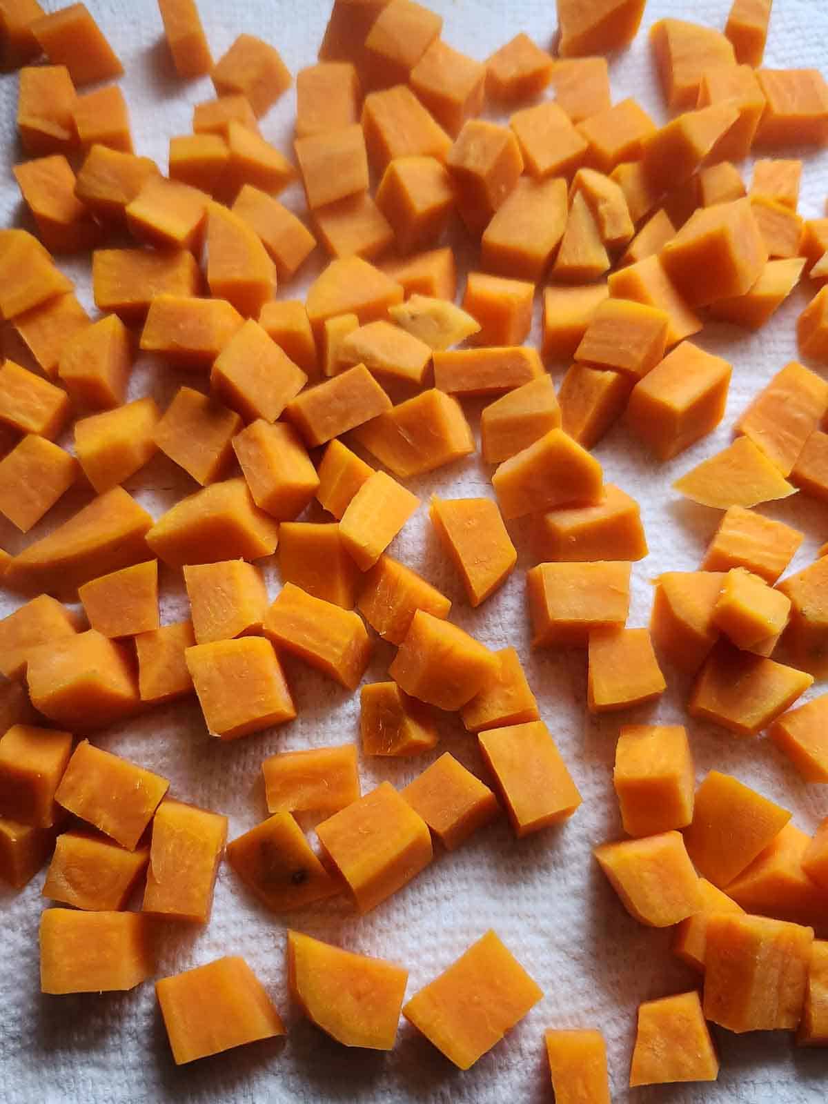 Sweet potato cubes drying on a paper towel.