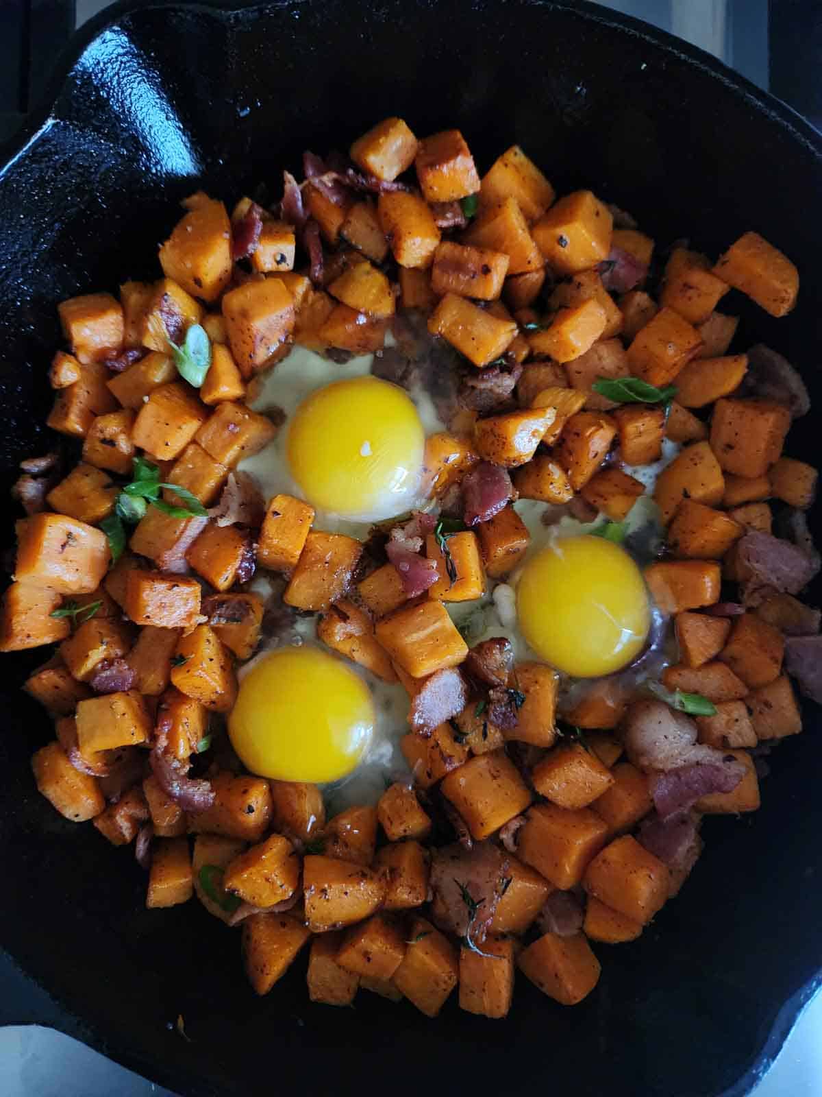 Hash in a skillet with 3 eggs in the center.