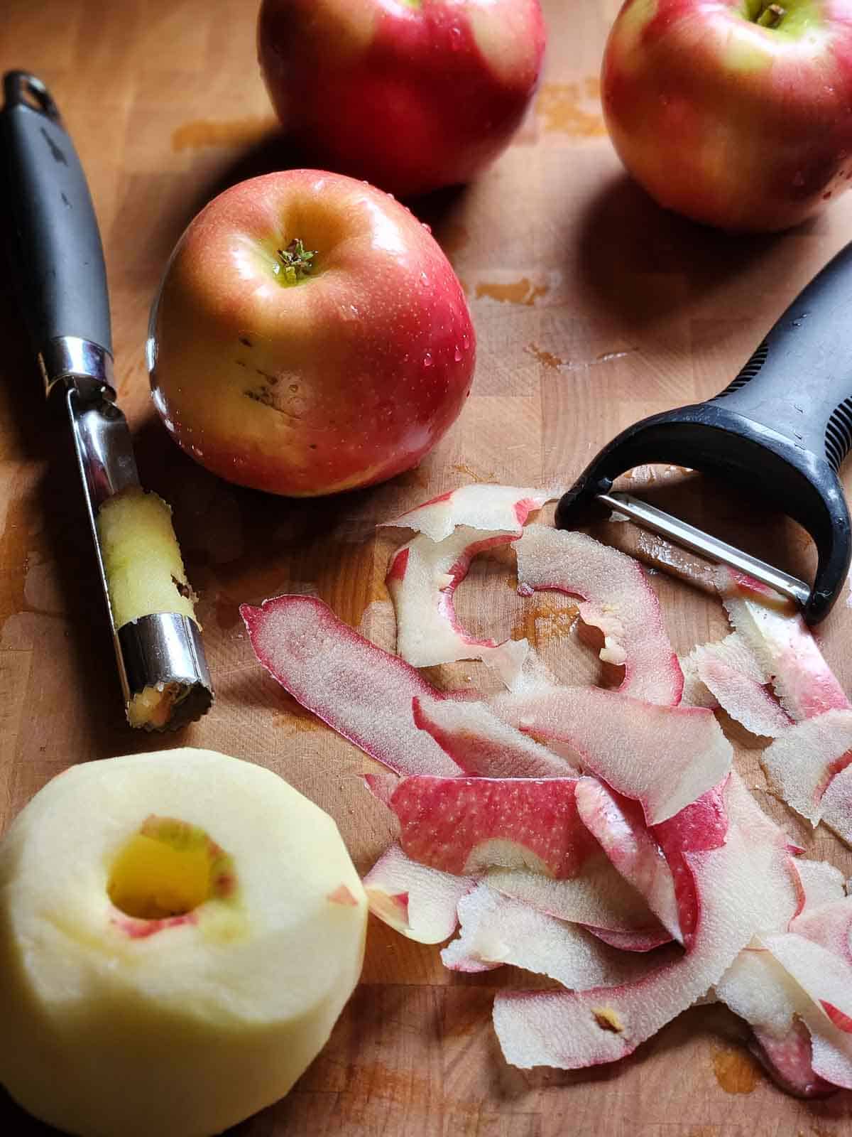 Peeled and cored apple on a cutting board.