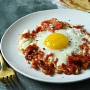 Close-up of sun-dried tomato and feta fried egg.