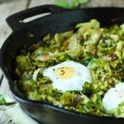 Close-up of Brussel sprout hash in a black skillet.