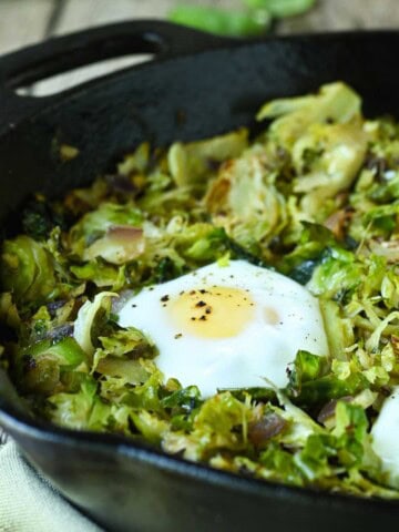 Close-up of Brussel sprout hash in a black skillet.