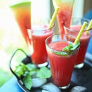 Three glasses of watermelon water by the window.