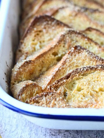 Close-up of French toast casserole in a white pan.