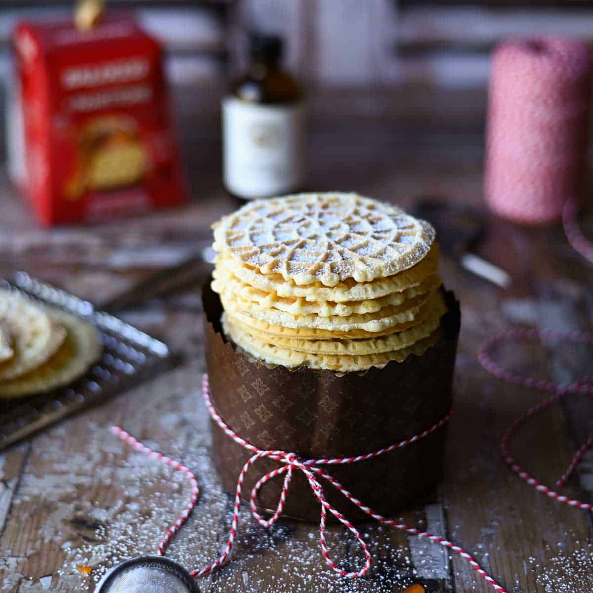 Stack of pizelle cookies in a panettone wrapper.