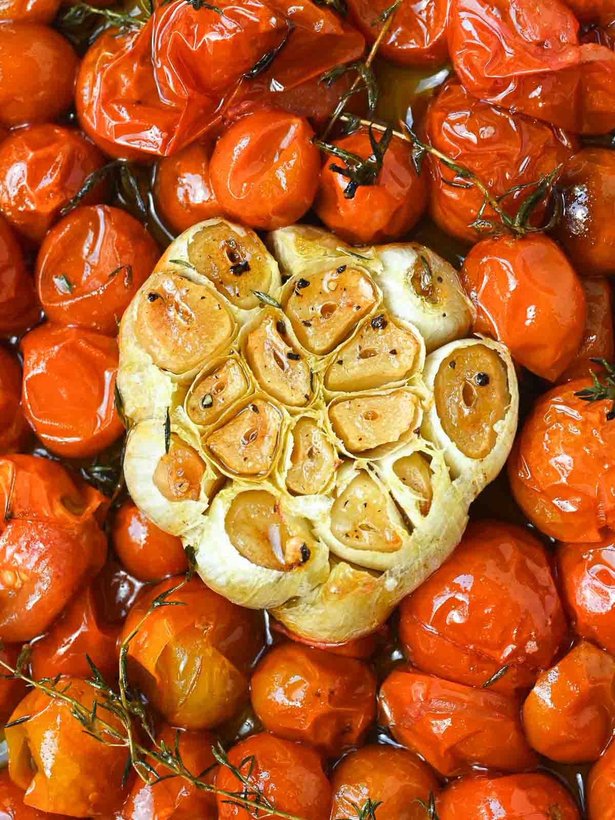 Overhead of cherry tomato confit and roasted garlic.