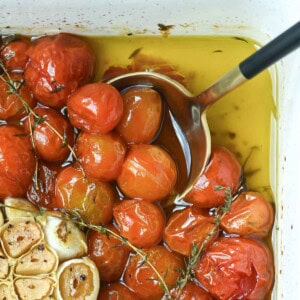 Overhead of cherry tomato confit in a baking dish.