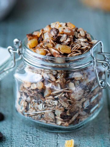 Close-up of chocolate muesli in a clear mason jar.