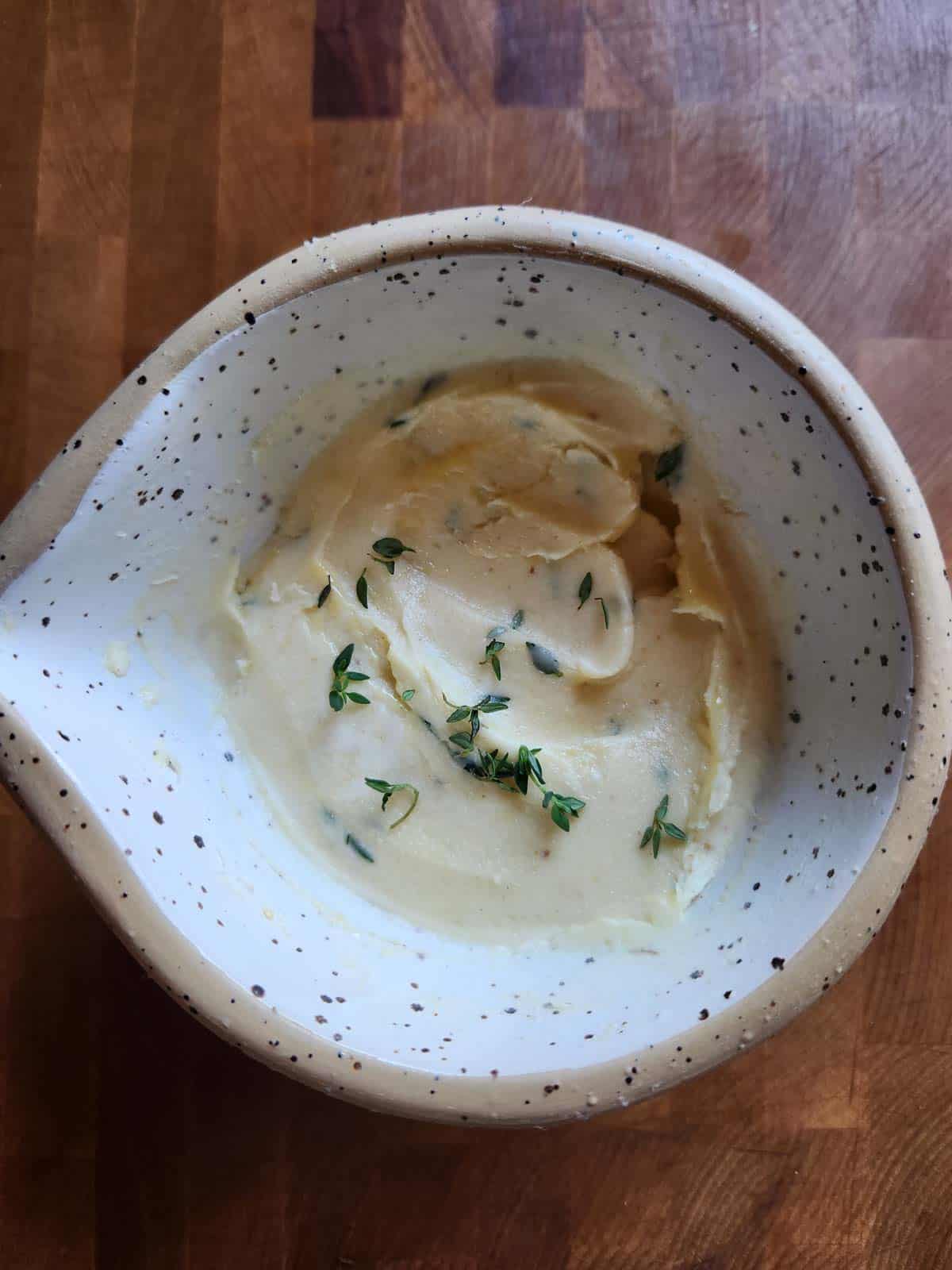 Blended flavored butter in a beige bowl.