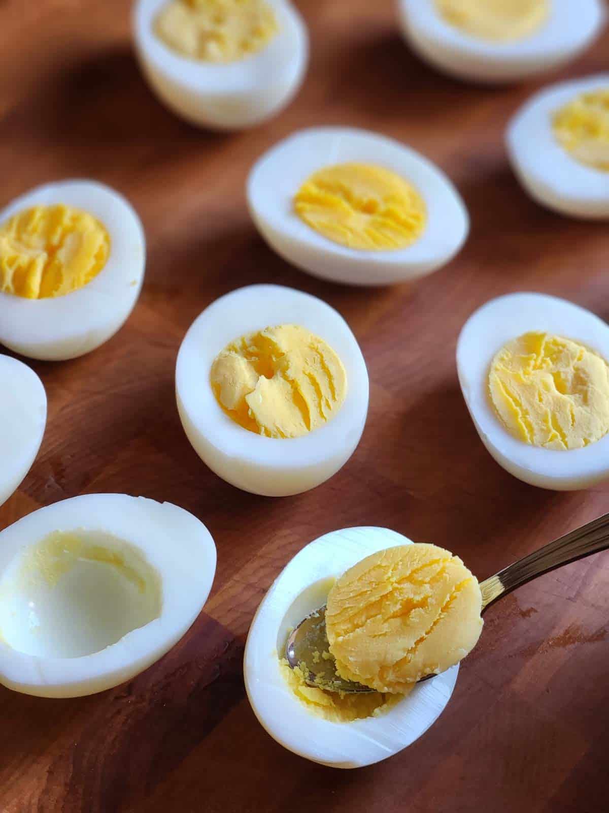 Yolks being removed from hard boiled eggs.