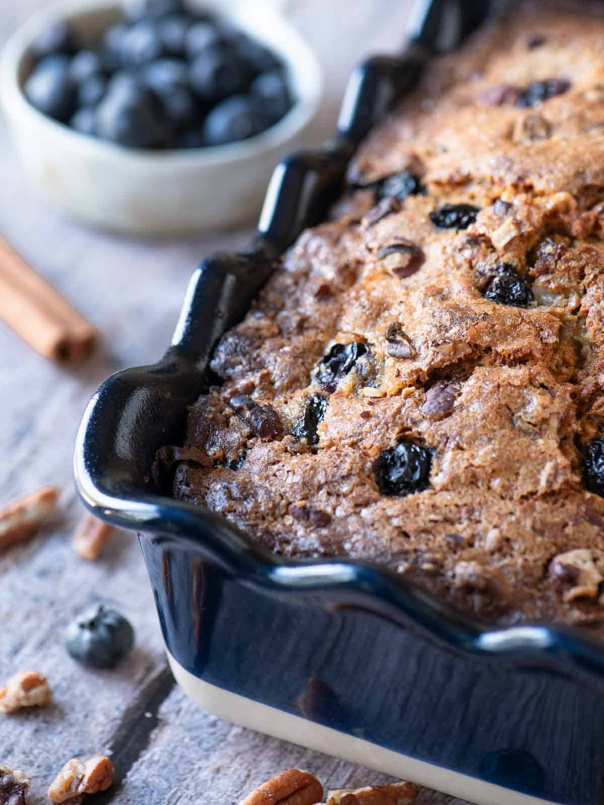 Close-up of blueberry banana bread in a blue ruffled loaf pan.