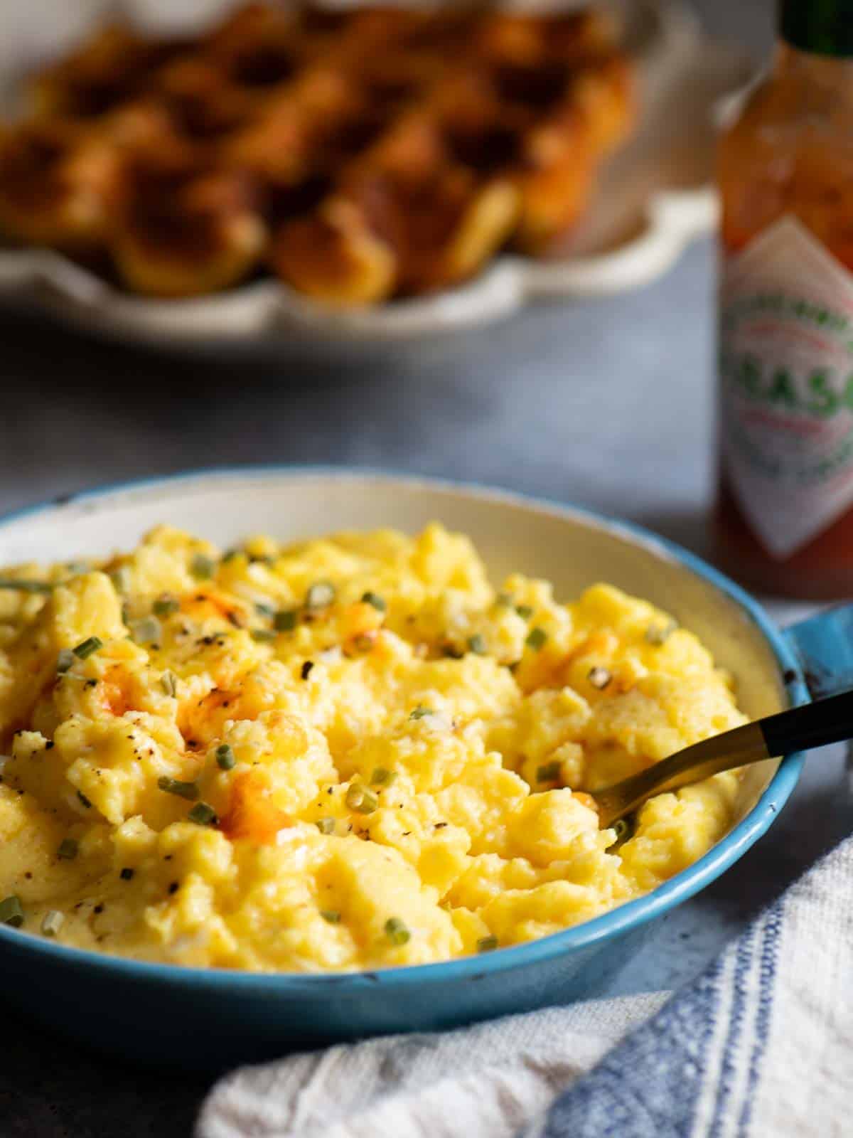 Close up of scrambled eggs with Tobasco sauce on it.
