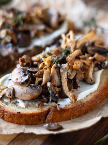 Close up of mushroom toast on parchment paper.