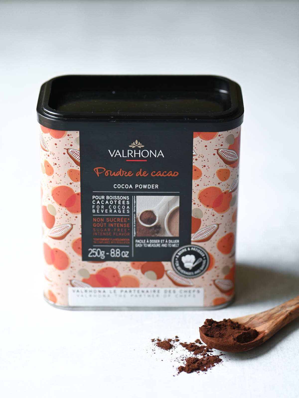 A box of Valrhona cocoa powder on a white surface.