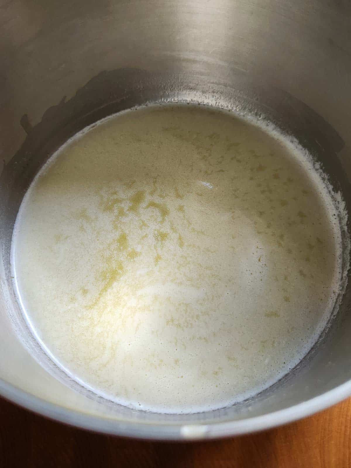 Melted butter in a metal bowl.