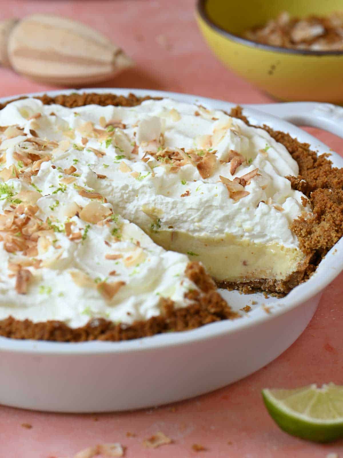 Key lime pie cut open in a pie plate to show the inside.