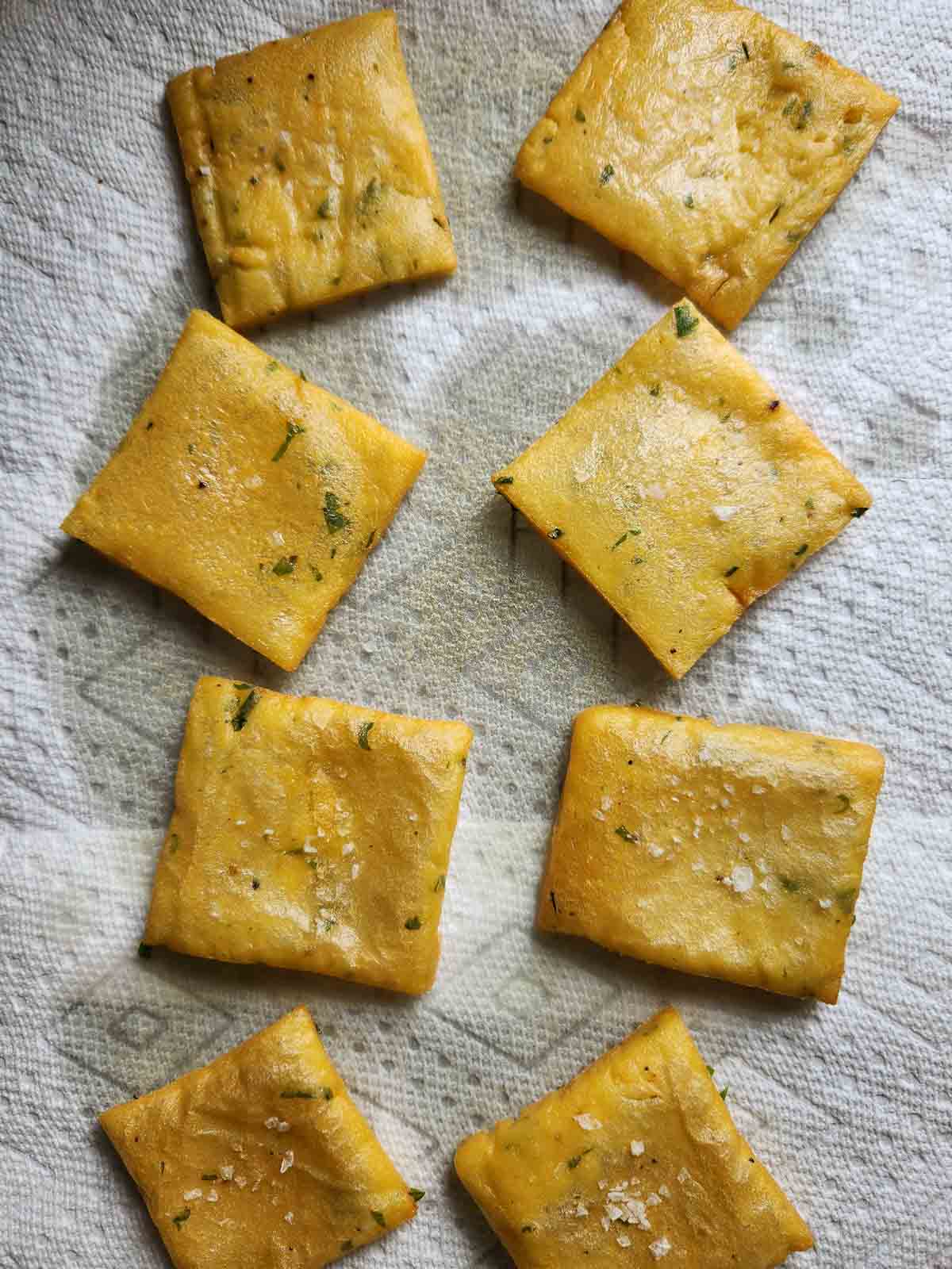 Overhead of cooked panelle on paper towels to drain.