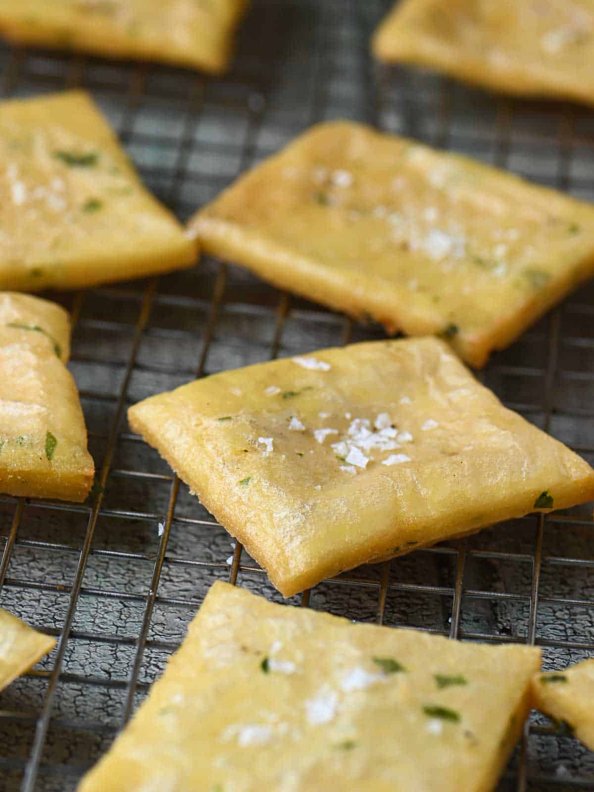 A cooling rack with some fritters on it.