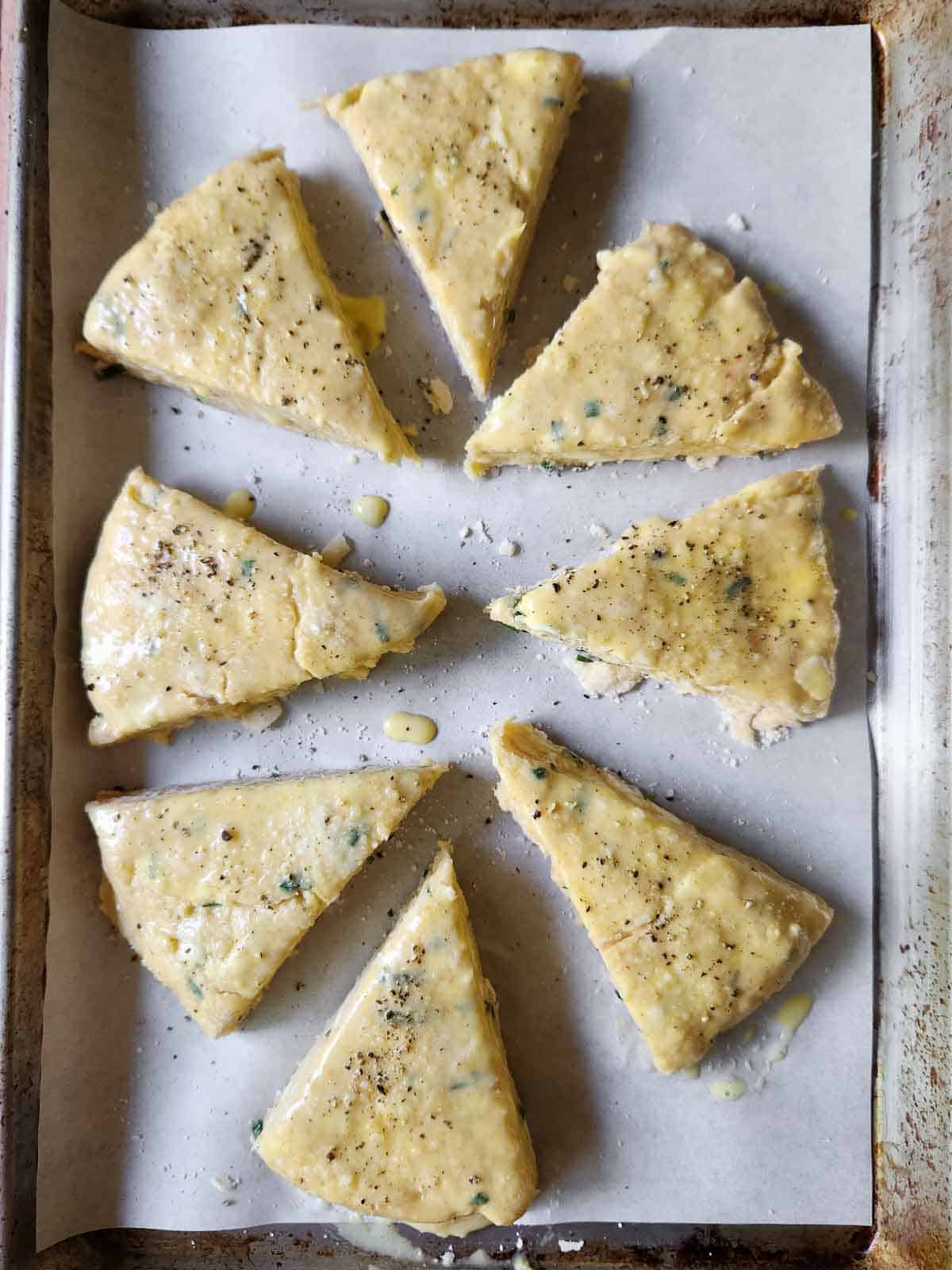 Overhead of scones ready for the oven on a baking pan.