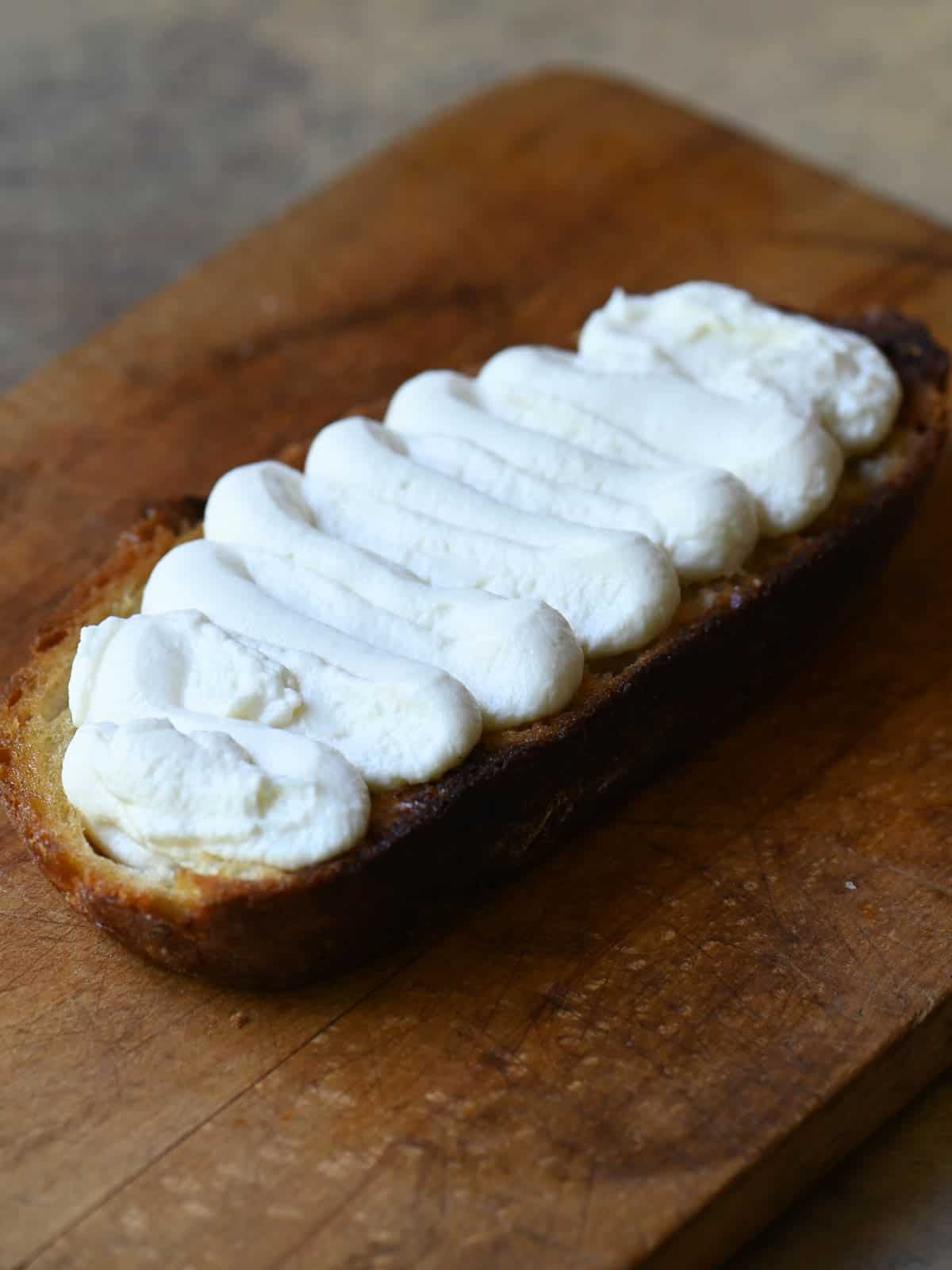 Ricotta toast on a cutting board.