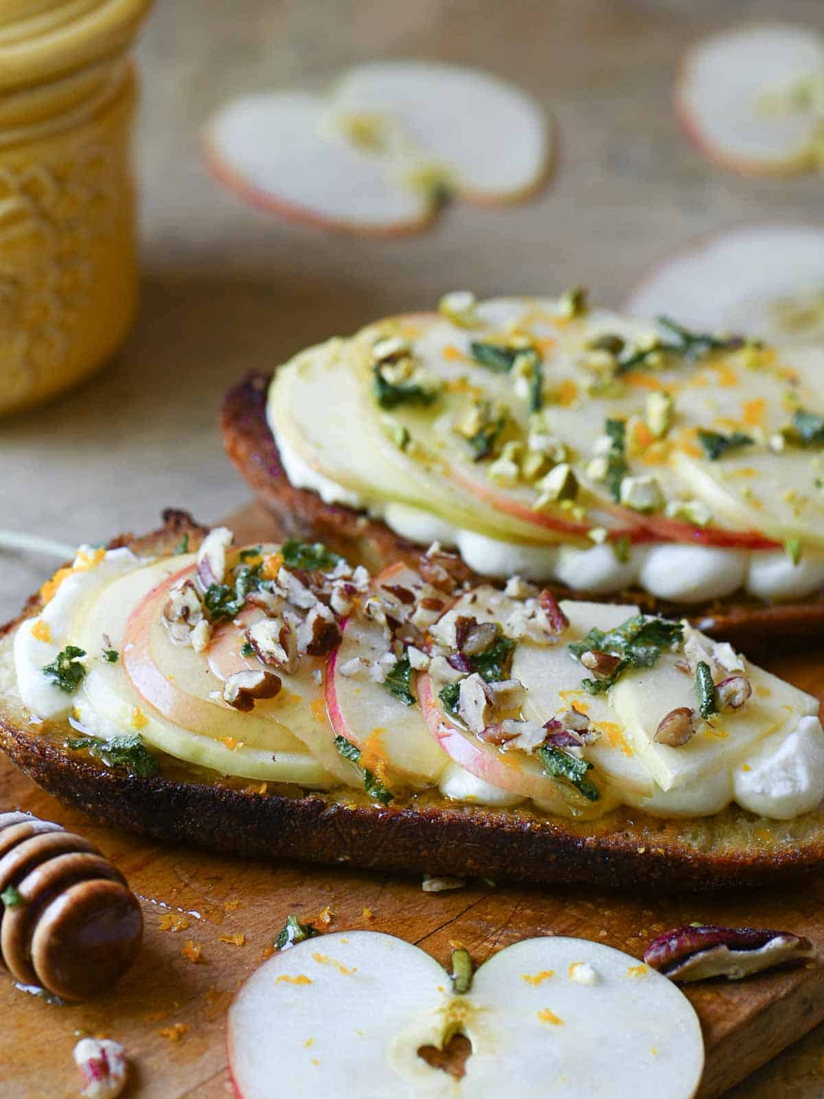Two slices of apple toast on a cutting board.